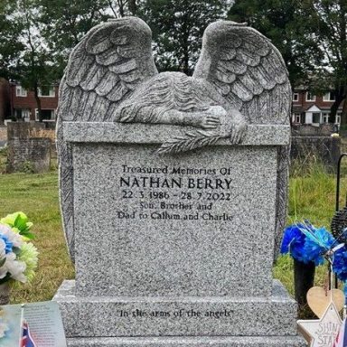 Weeping Angel headstone in a light grey granite