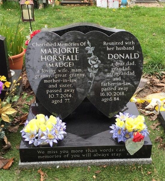 Double heart cremation memorial in black granite with rose divider