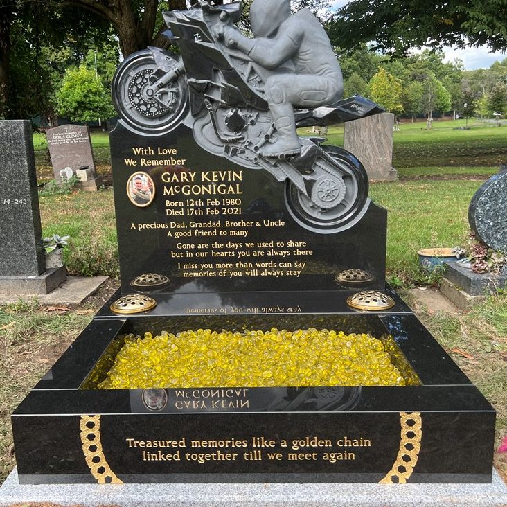 Motorbike memorial with deep grave surround and yellow chippings