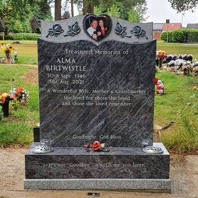 Bahama Blue Book granite memorial with carved and bronze roses, heart shaped ceramic portrait mounted into polished granite heart