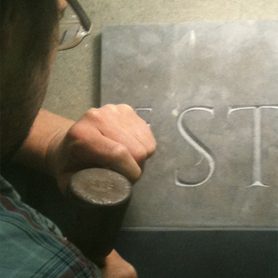 Hand cut lettering in slate