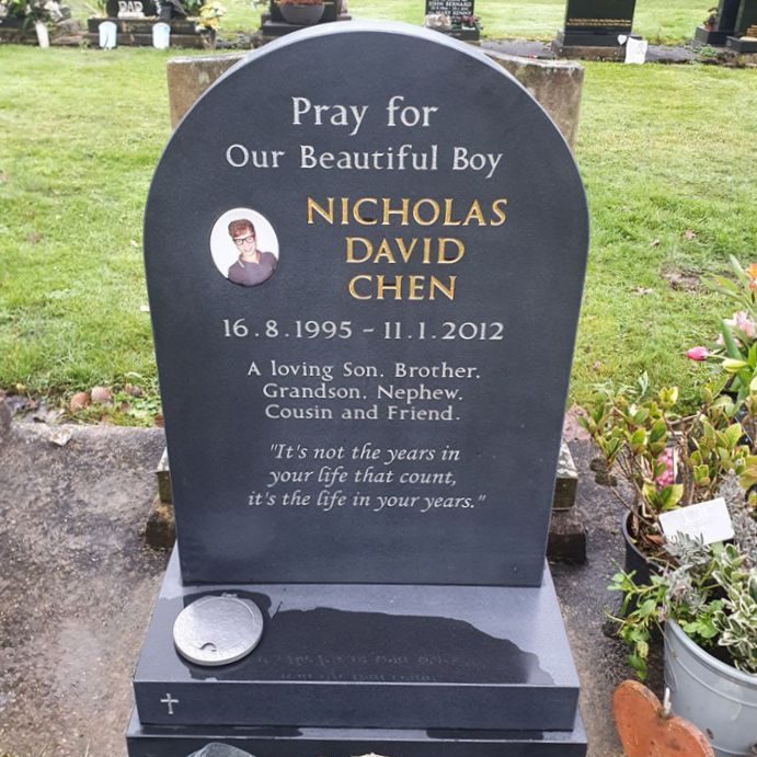 Slate dome shaped headstone with contrasting gold and silver lettering. Strassacker aluminium flower container