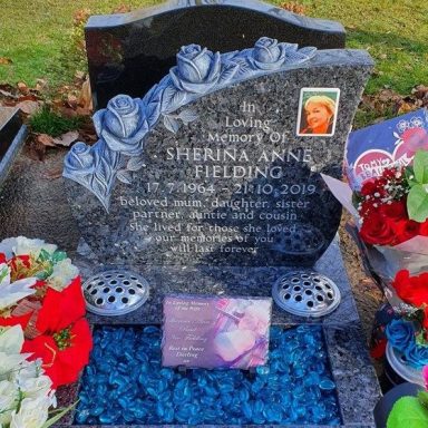 Bespoke cremation memorial carved with roses from a discussion held with the customer