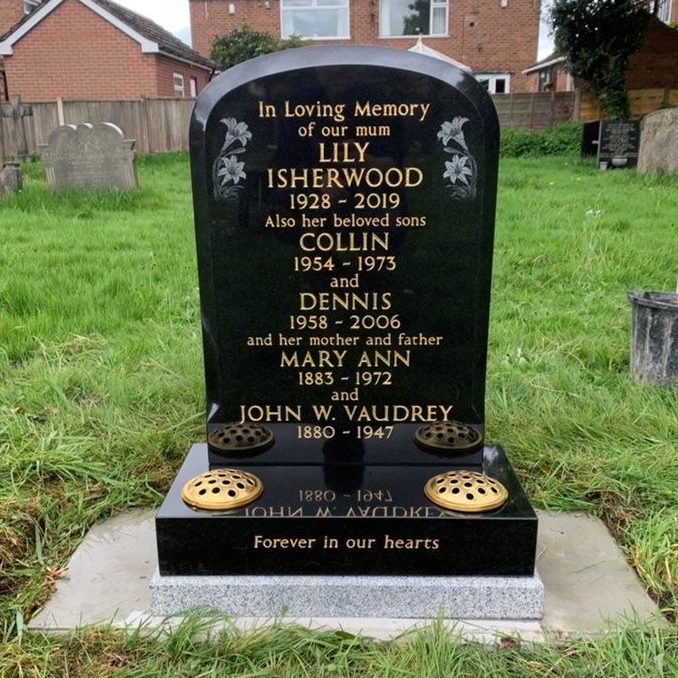 Black granite memorial with etched lily design